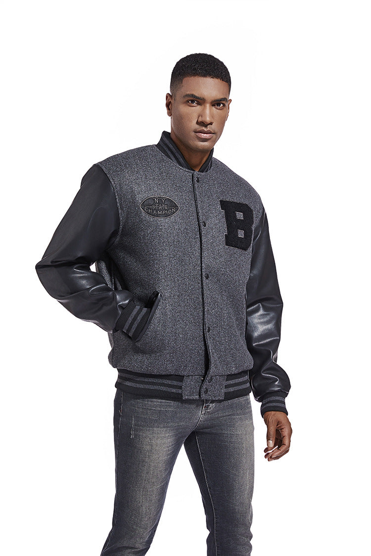 Man wearing a gray varsity American Baseball Jacket  with black leather sleeves on a white background