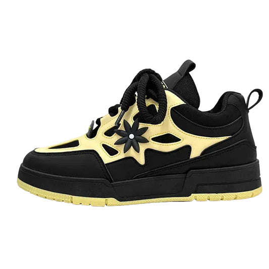 Black and yellow sneaker with floral design on a white background