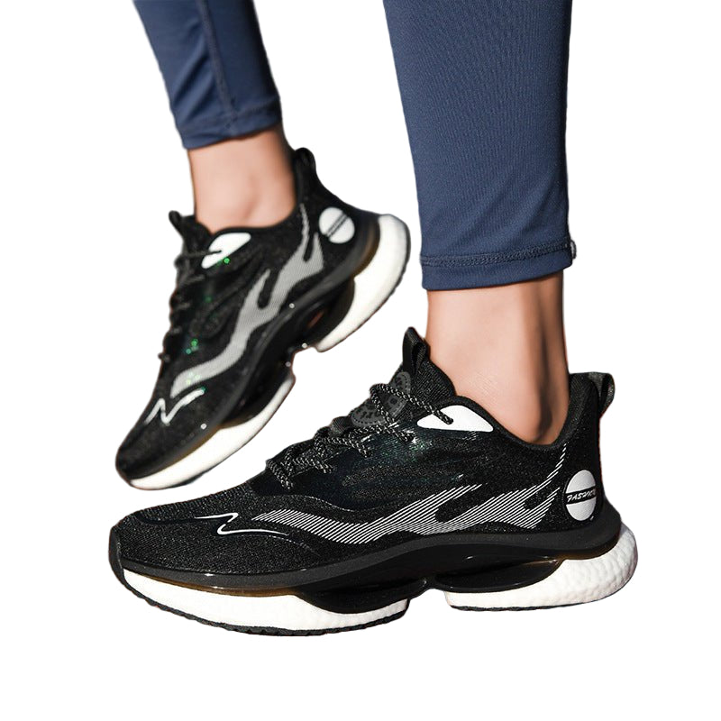 Black and white running shoes on a person's feet on a track