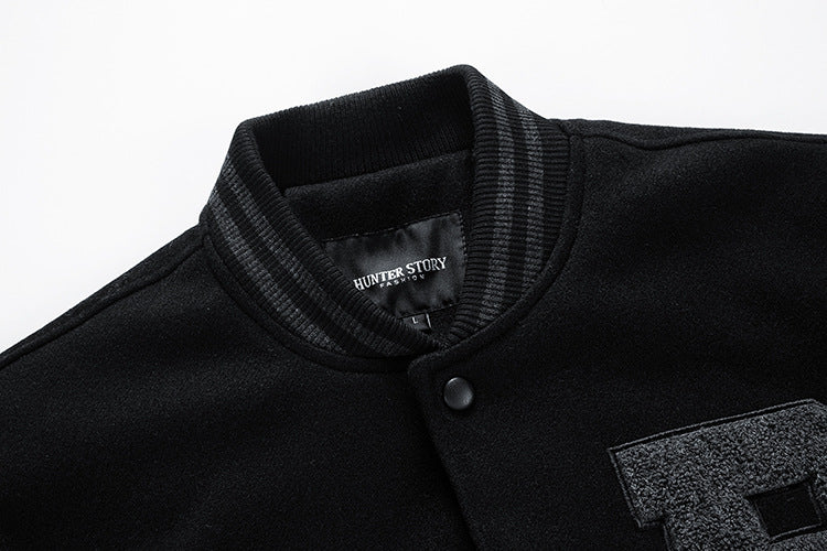 Close-up of a black jacket with a brand label on a white background