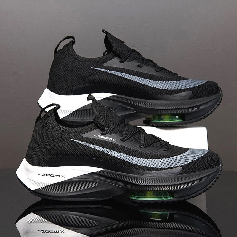 Black and gray athletic shoes with 'zoom x' branding on a reflective surface.