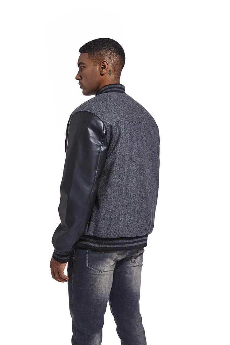 Man wearing a gray American Baseball Jacket with leather sleeves on a white background