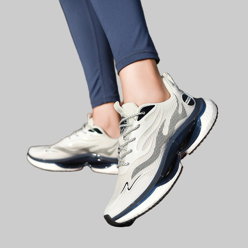 Person wearing white and navy running shoes on a track