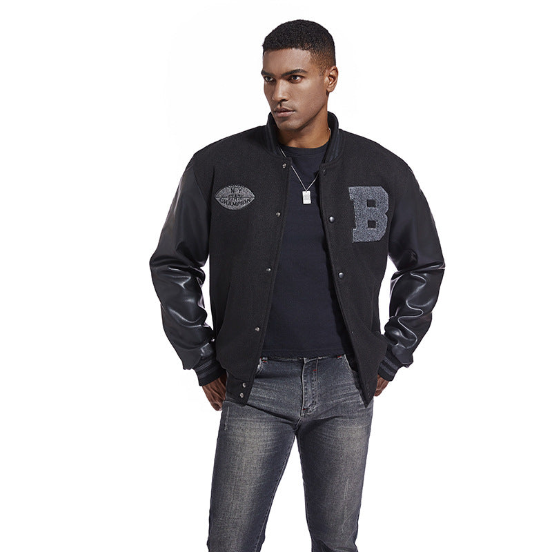 Man wearing a black varsityAmerican Baseball Jacket with leather sleeves on a white background