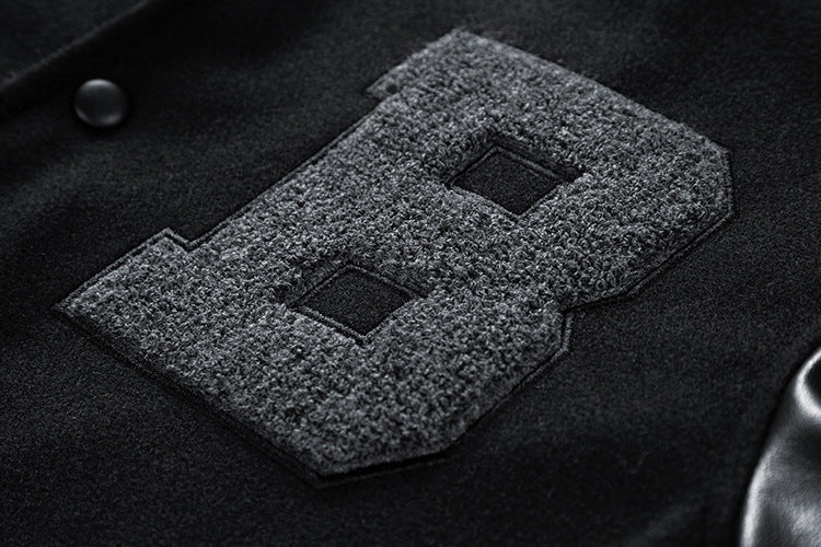Textured patch with 'B' on a dark fabric background