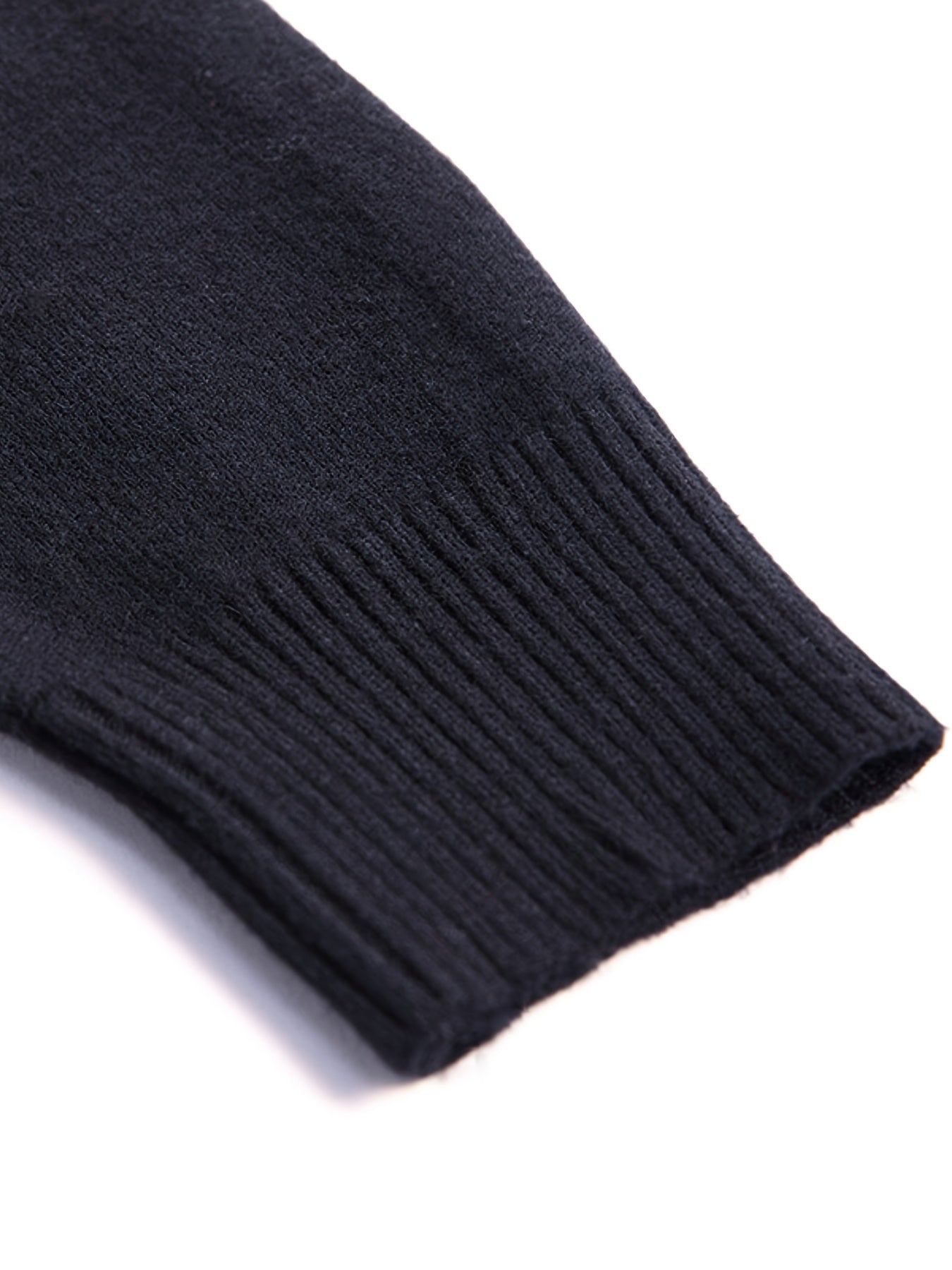 Close-up of a dark blue knitted sweater sleeve on a white background