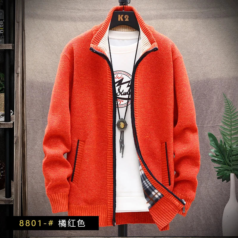 Orange cardigan on a hanger with a white shirt underneath, against a neutral background.