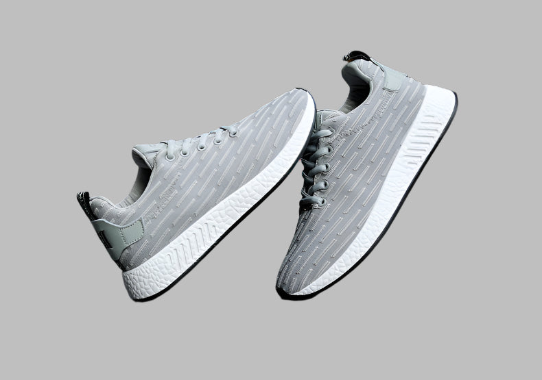 Gray sneakers with white soles on a gray background