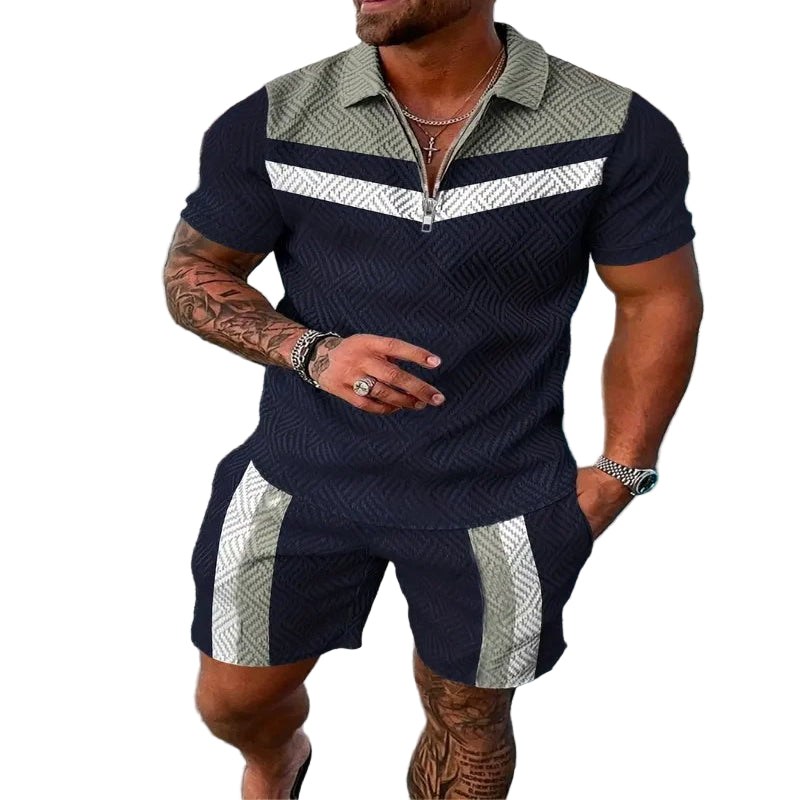 A man wearing a geometric patterned casual beach shorts set with a polo shirt and short-sleeves, standing near a pool.