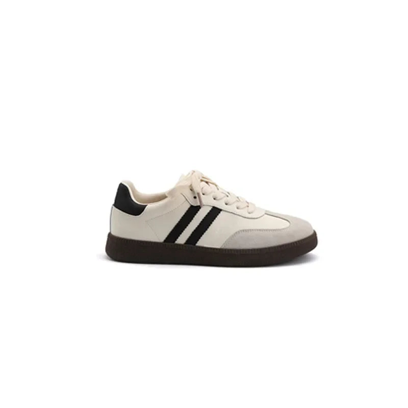 White sneaker with black stripes on a white background
