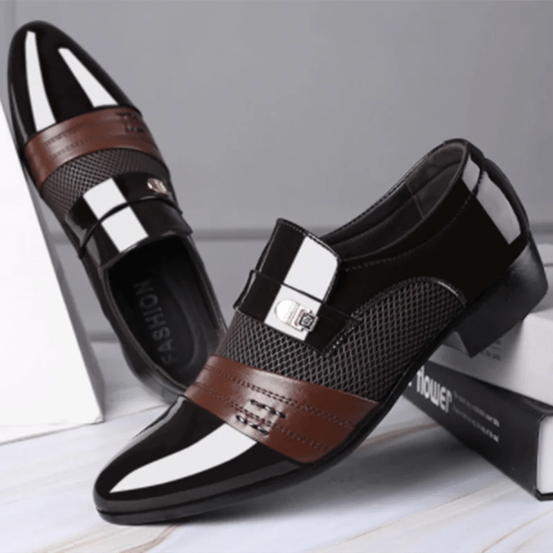 Black and brown Luxury Leather Men's Shoes with a silver buckle on a white surface.