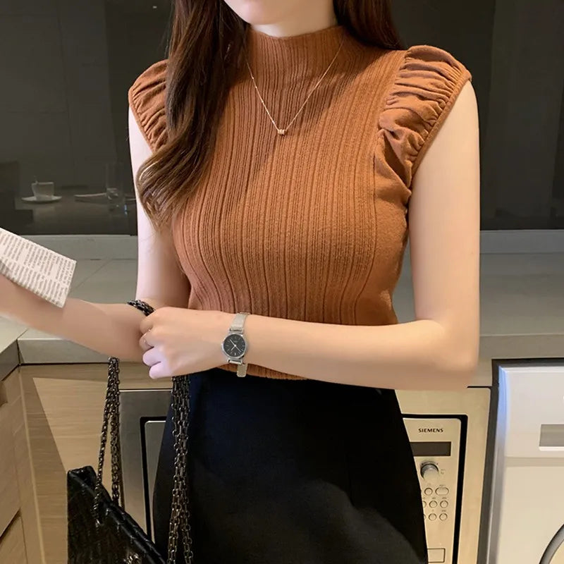 Woman wearing a brown ribbed sleeveless top in a kitchen setting