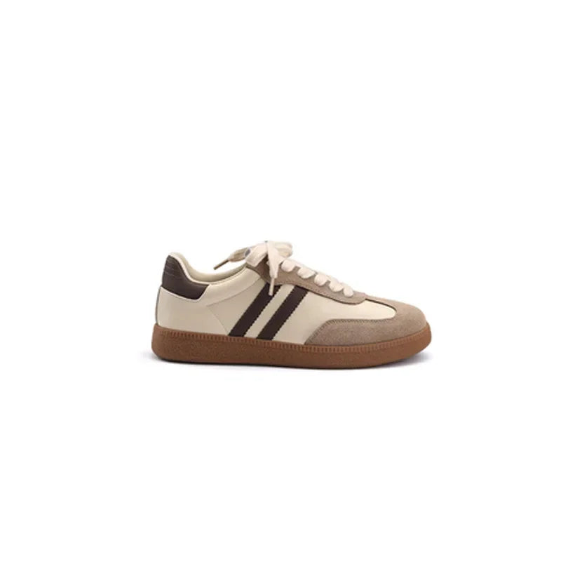 Beige and brown sneaker with three black stripes on a white background