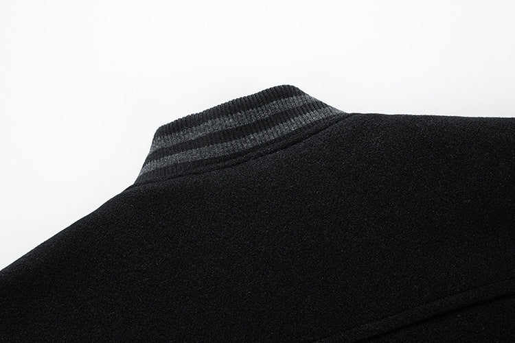 Close-up of a black jacket with a textured collar on a white background